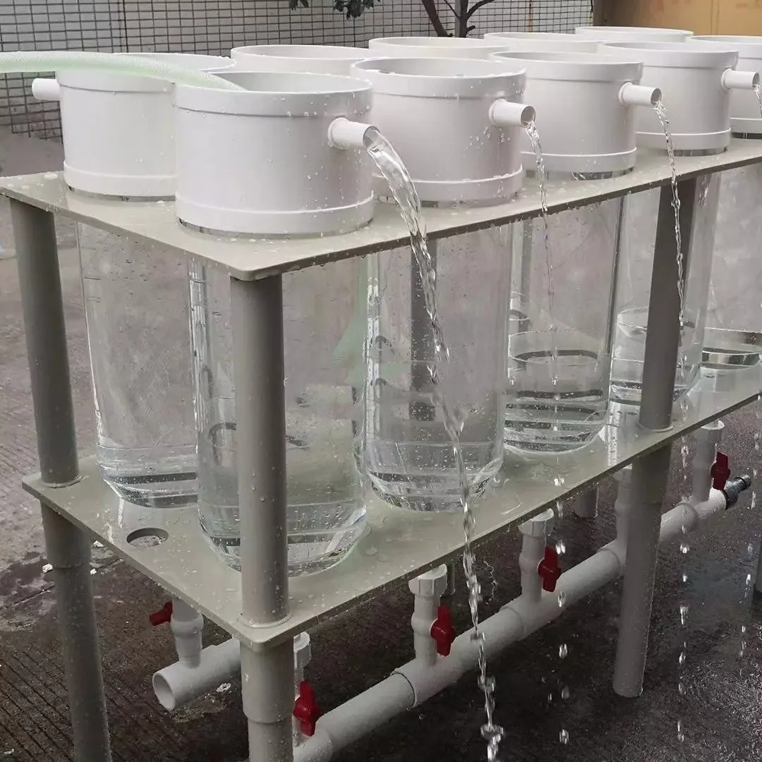 A row of transparent fish-egg incubation vessels with flowing water; illustrative SIGMA Aquaculture equipment photograph